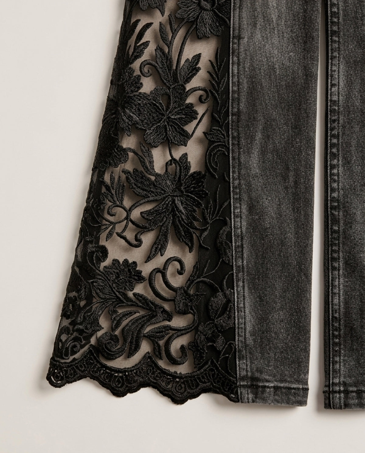 Close-up of the sheer mesh panel with raised floral embroidery and scalloped hem