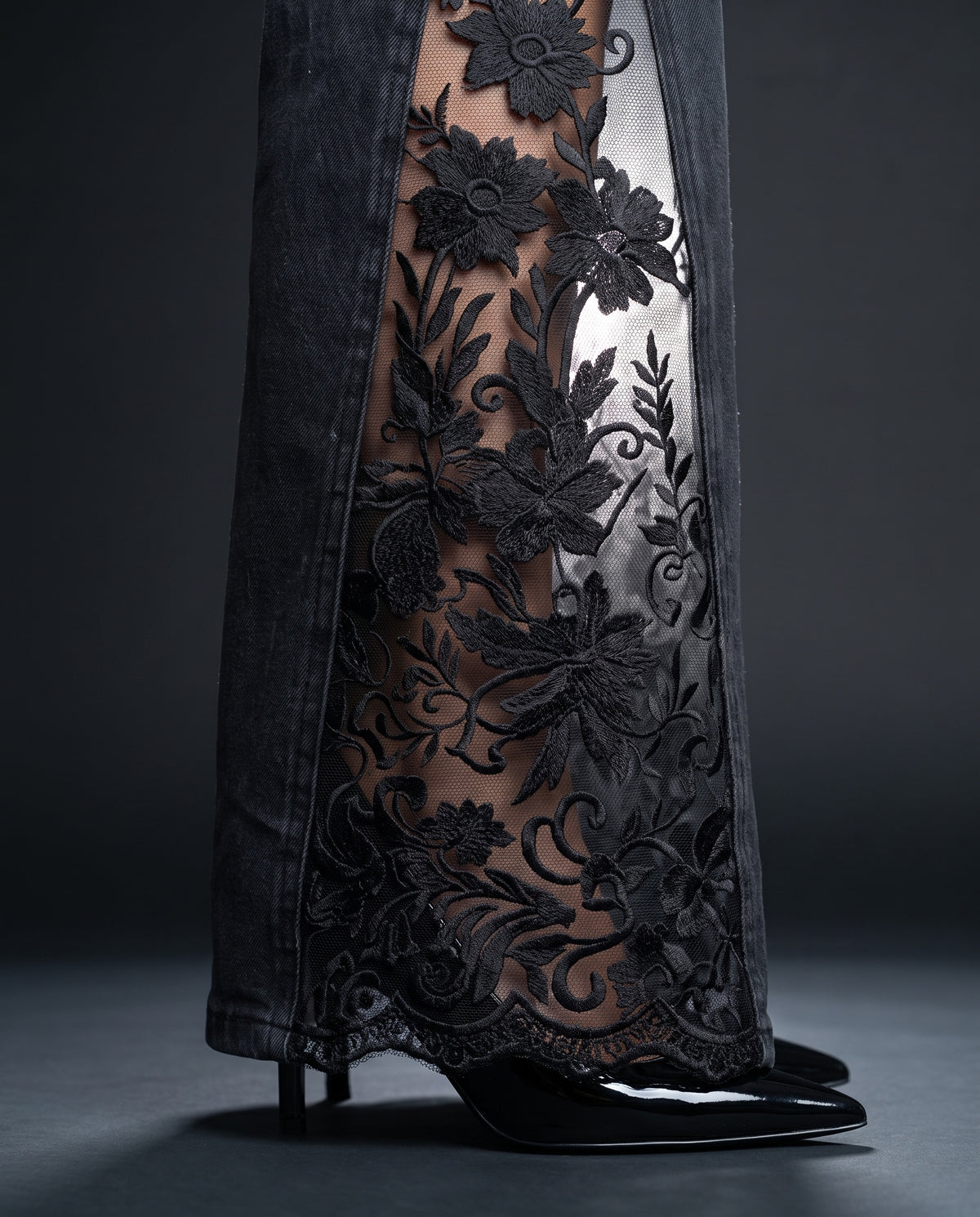 Close-up of the raised floral embroidery and scalloped lace hem